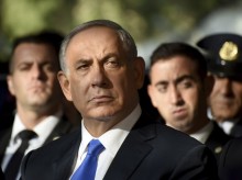 Israeli leader vows to carry on despite corruption charges